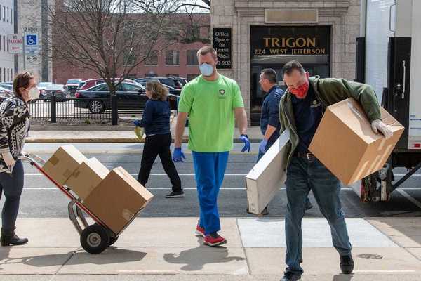 Workers from St. Joesph County Department of Health unload boxes of donated protective gear from Notre Dame at the County City Building in South Bend.